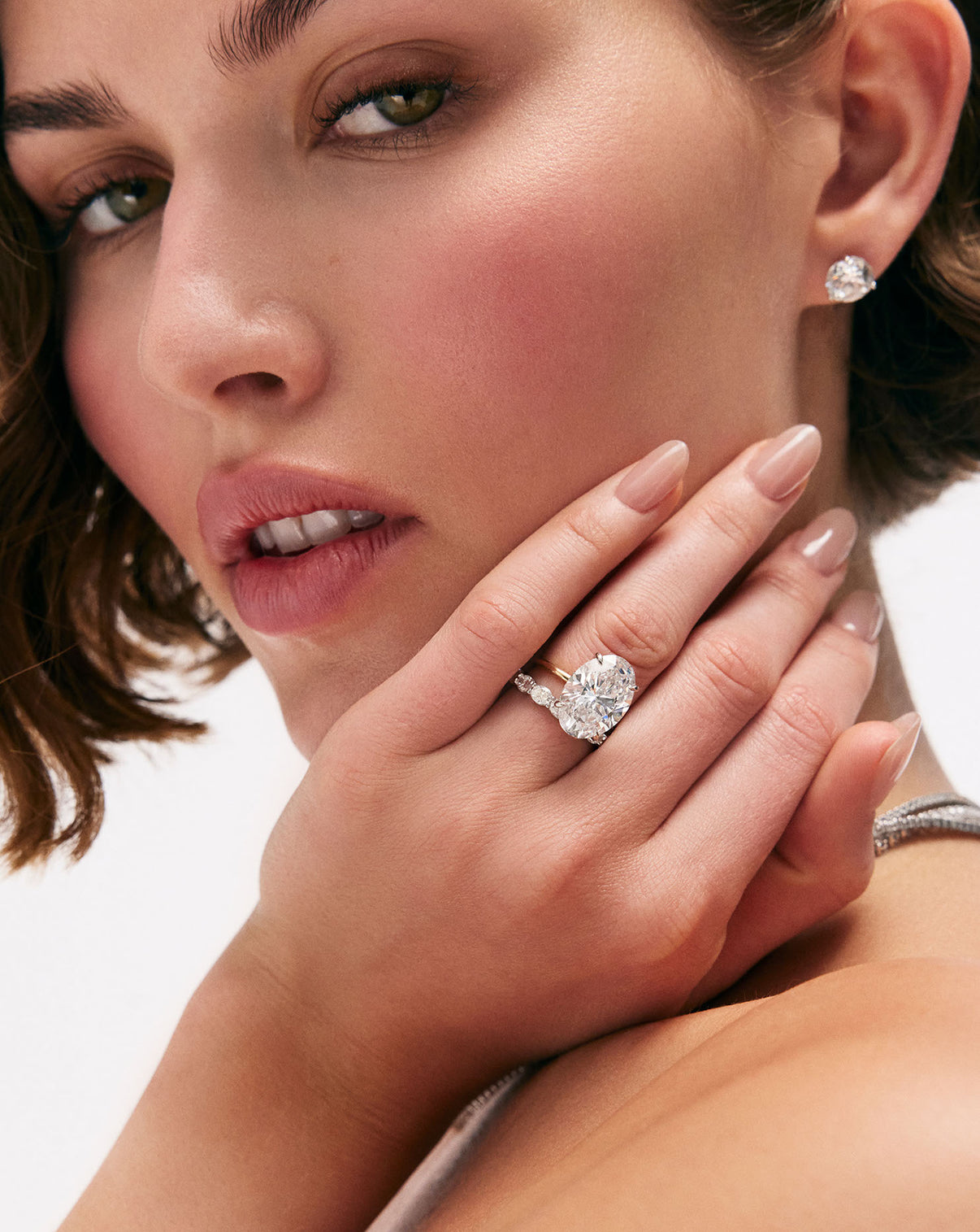 6 carat Oval Diamond Engagement Ring in Yellow Gold Whisper Thin Hidden Halo band with Platinum Prongs shown on model with a diamond wedding band