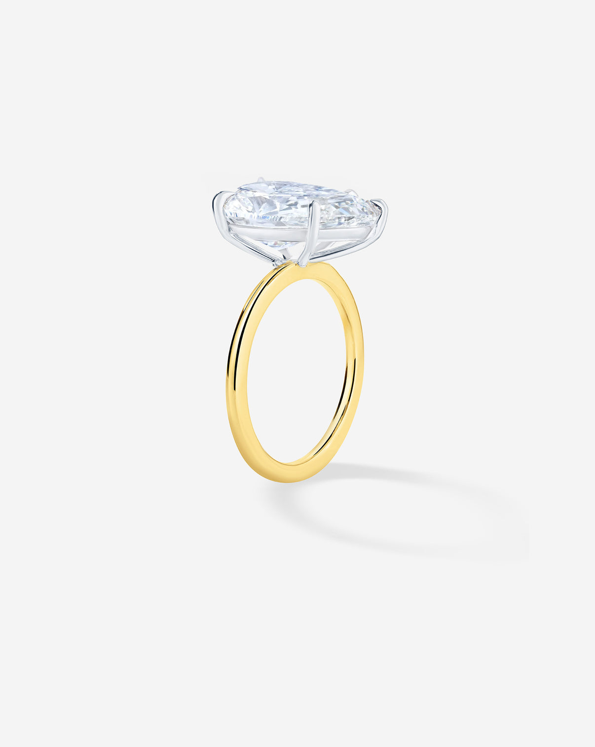 Side view of 3 carat Pear diamond engagement ring with Yellow Gold Whisper Thin band and Platinum Prongs
