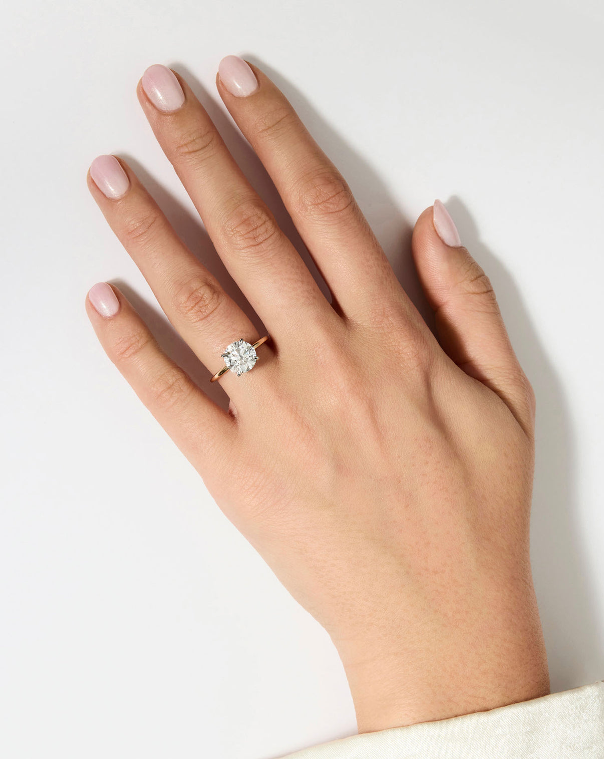 3 carat Round Diamond Engagement Ring in Yellow Gold Whisper Thin band with Platinum Prongs shown on model's hand