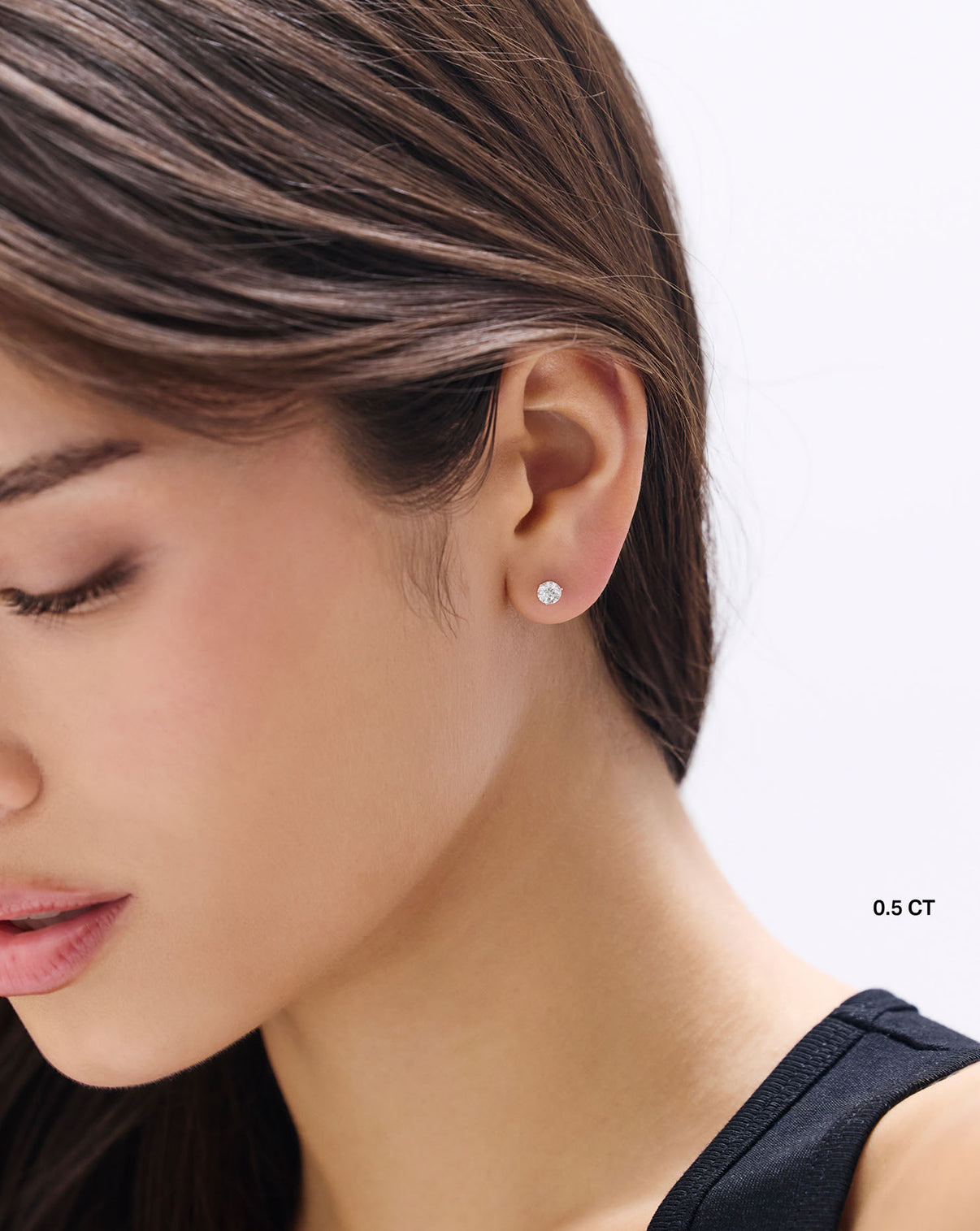 model wearing round studs 0.5 carat 42995392544856 43479336517720