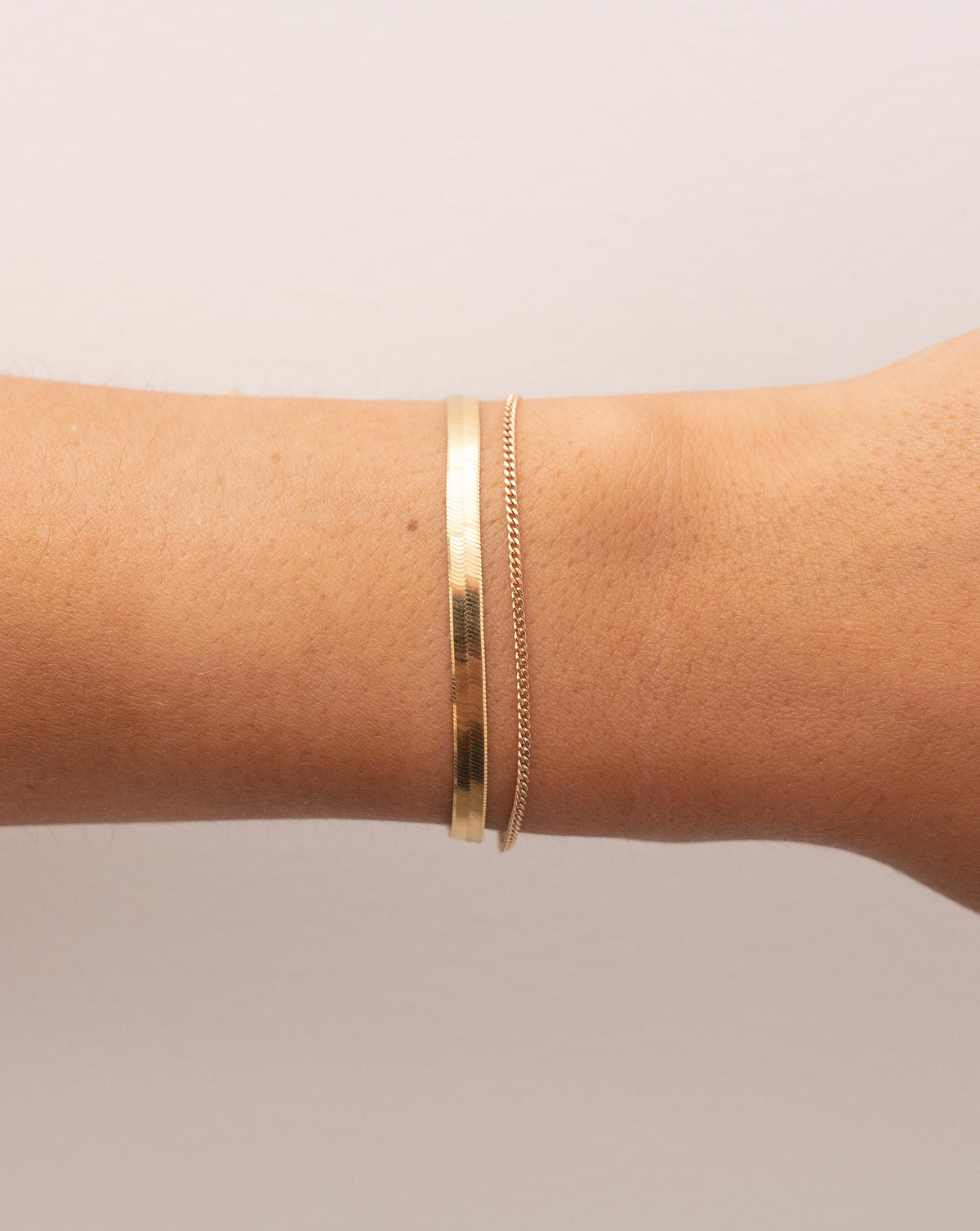 Diamond Cut Curb Chain Bracelet worn with the 4 mm Herringbone Chain Bracelet on wrist