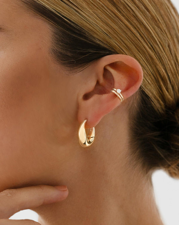 Movement Cloud Hoop worn on ear with Gold Ear Cuff and Single Diamond Ear Cuff