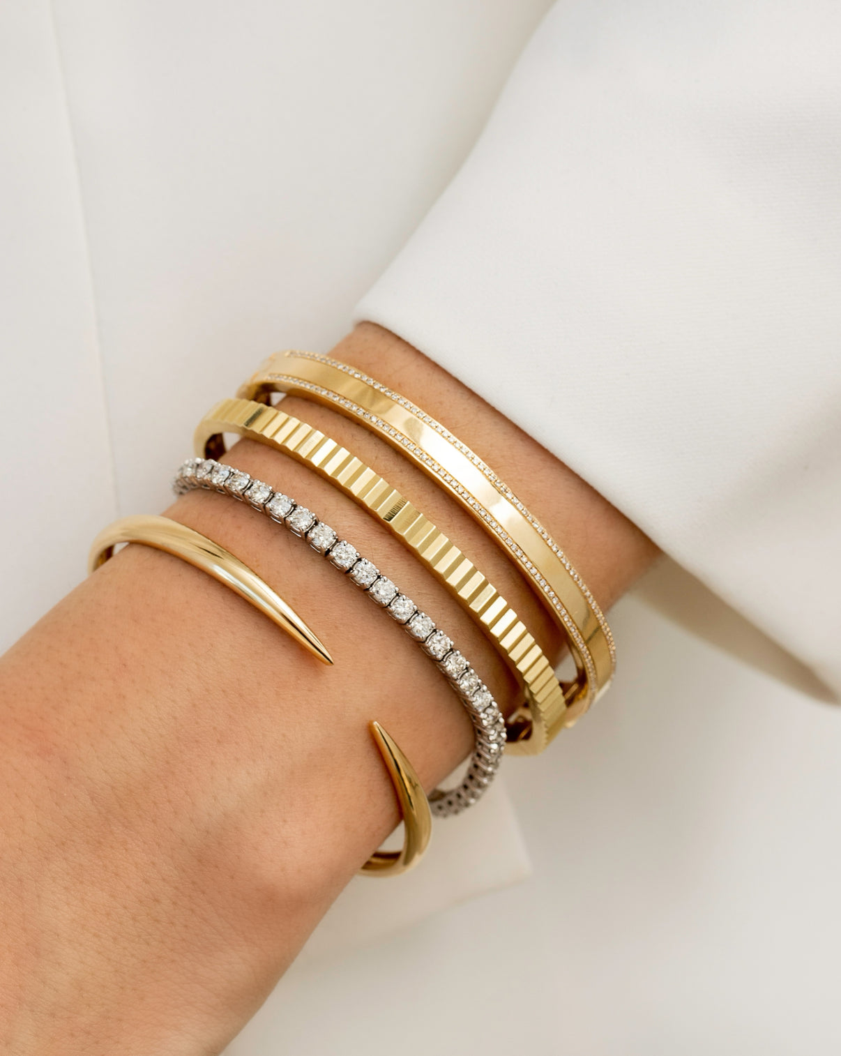 Gold Claw Cuff worn with the Classic Diamond Tennis Bracelet, Fluted Gold Bangle and the Diamond Border Bangle