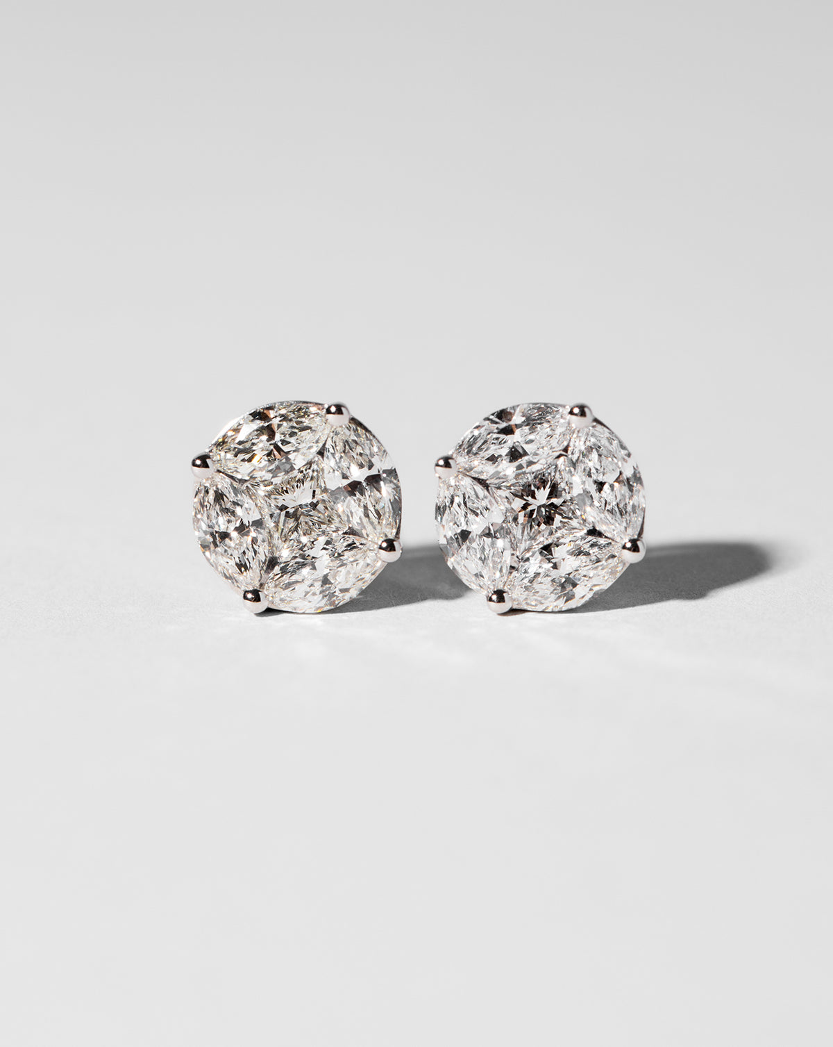 Flat lay of round illusion diamonds studs