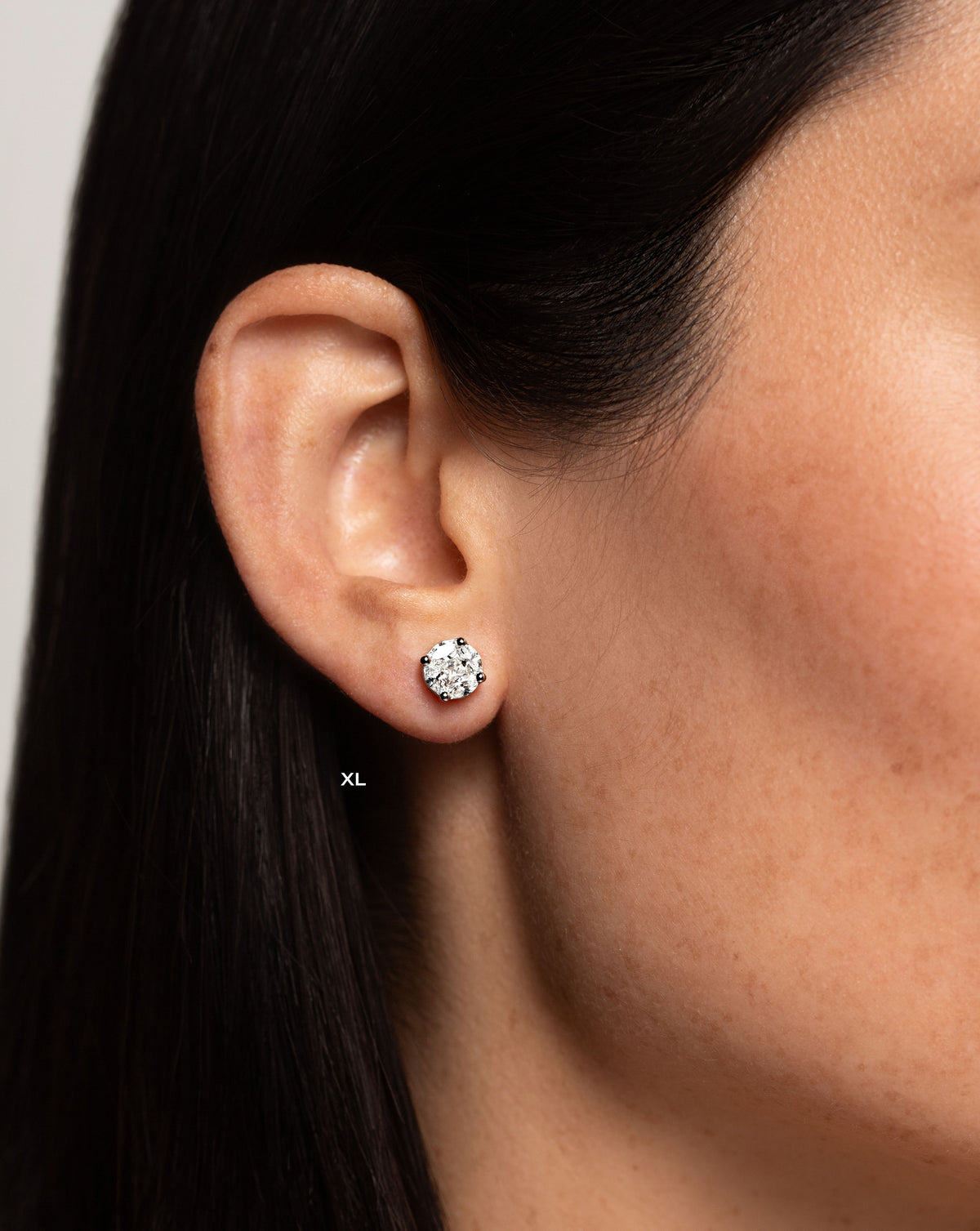 side view of model wearing round illusion diamond studs size XL