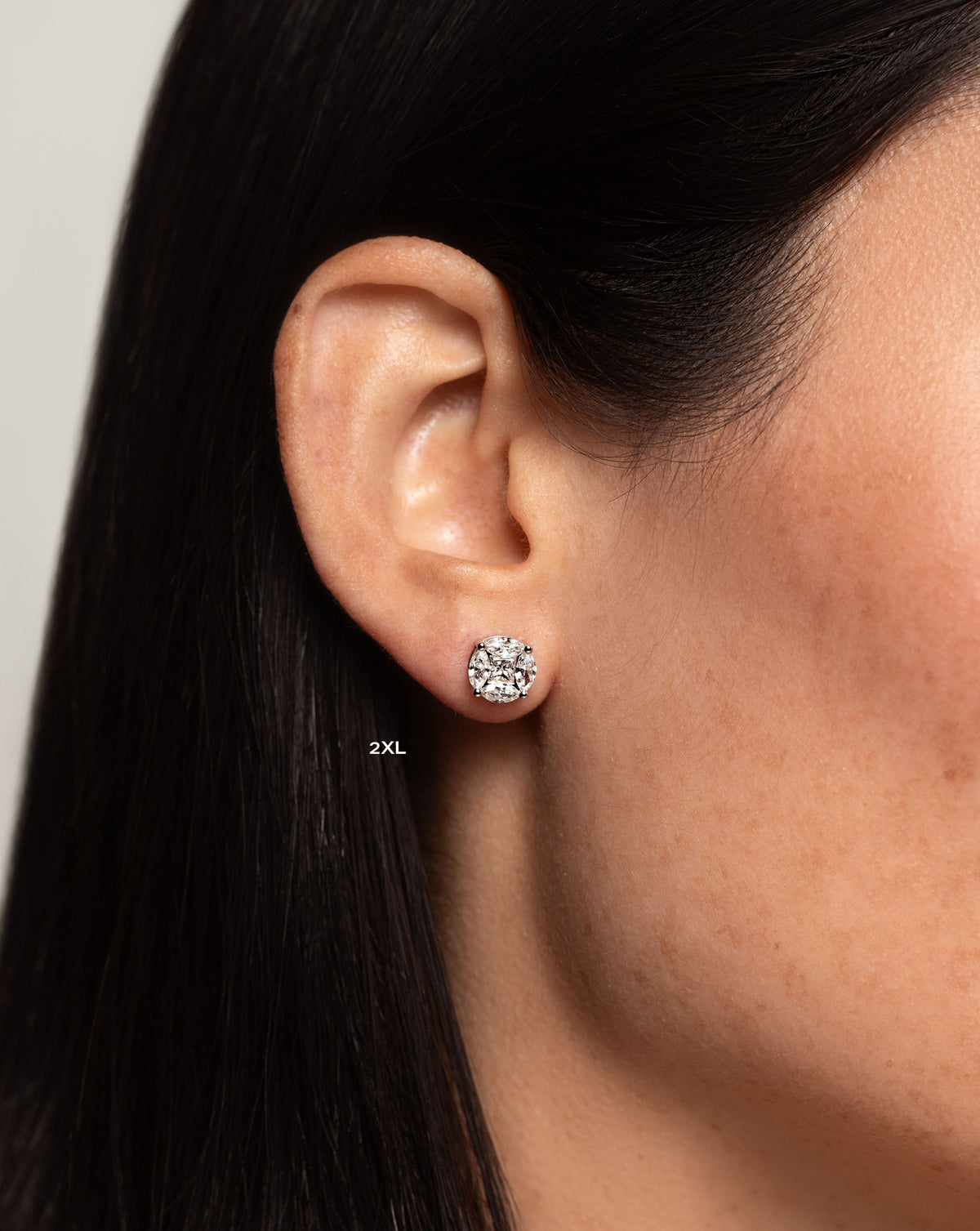 side view of model wearing round illusion diamond studs size 2X