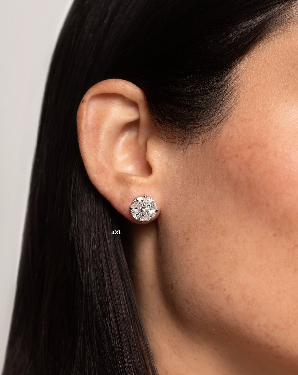 side view of model wearing round illusion diamond studs size 4X