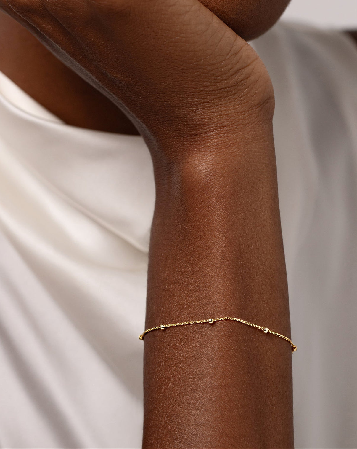 Saturn Chain Bracelet shown around wrist of model