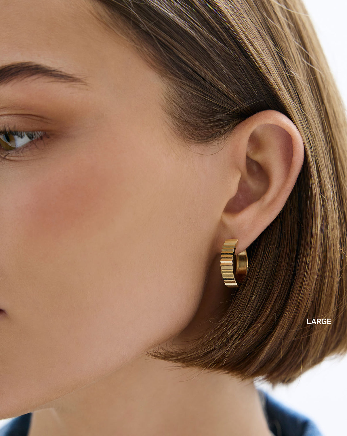 Wide Fluted Gold Hoops large on model. global
