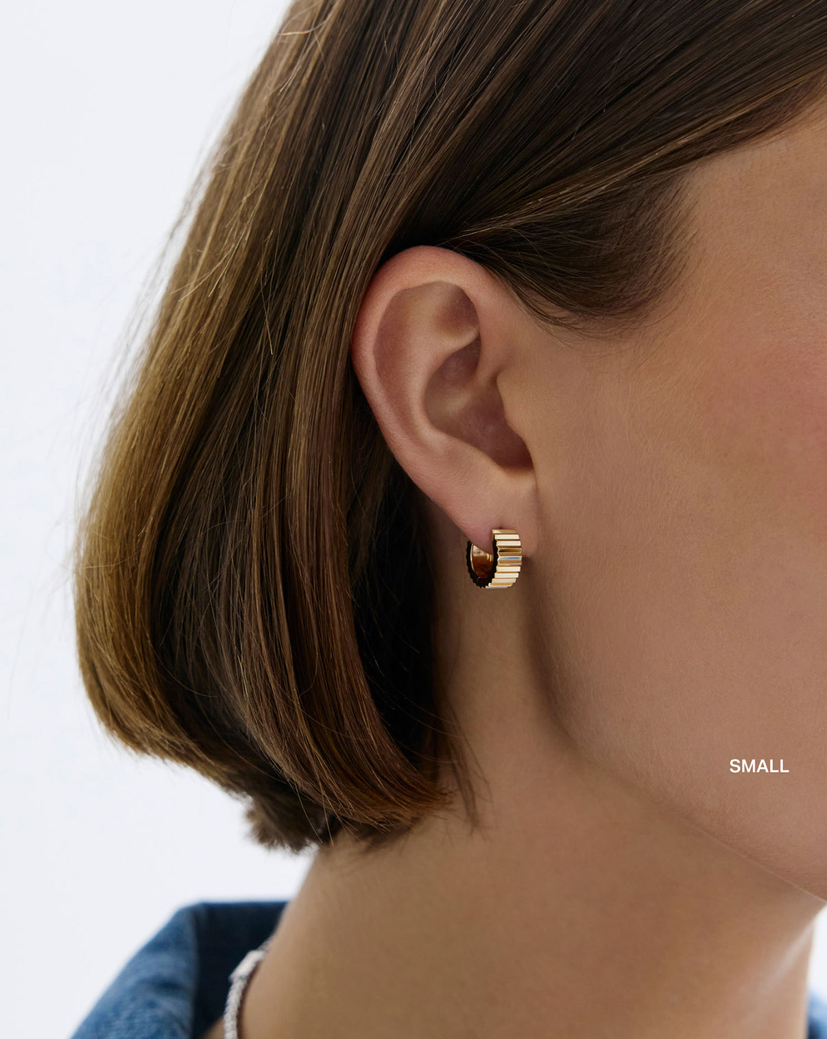 Wide Fluted Gold Hoops small on model. global