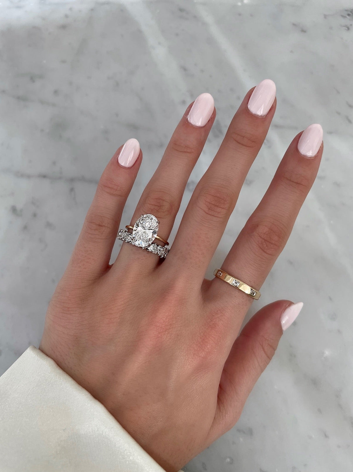 Bridal Wedding Bands Platinum Heart Shaped Eternity Band - styled with oval engagement ring on model