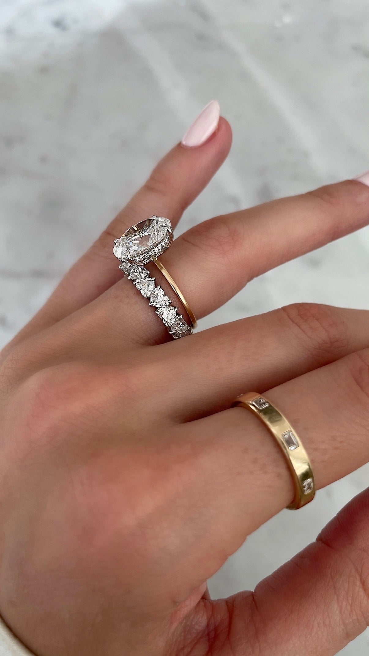 Bridal Wedding Bands Platinum Heart Shaped Eternity Band - styled with oval engagement ring on model
