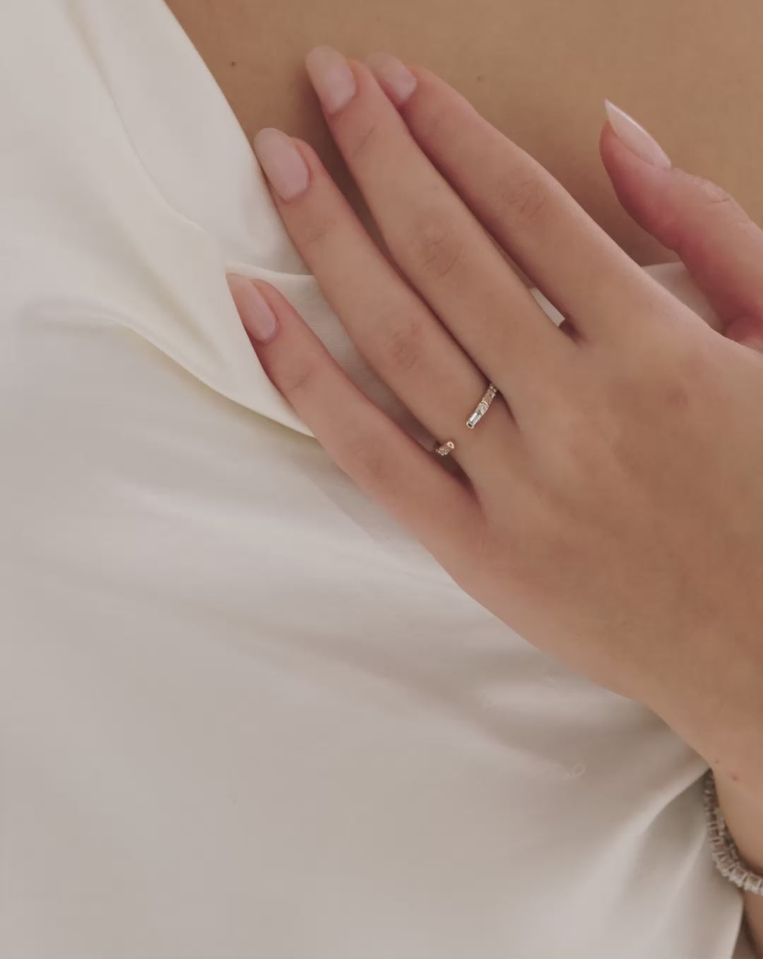 Video of a woman wearing the baguette open wedding band, stacked with the a Solitaire engagement ring. 14k Yellow Gold 14k Rose Gold 14k White Gold Platinum