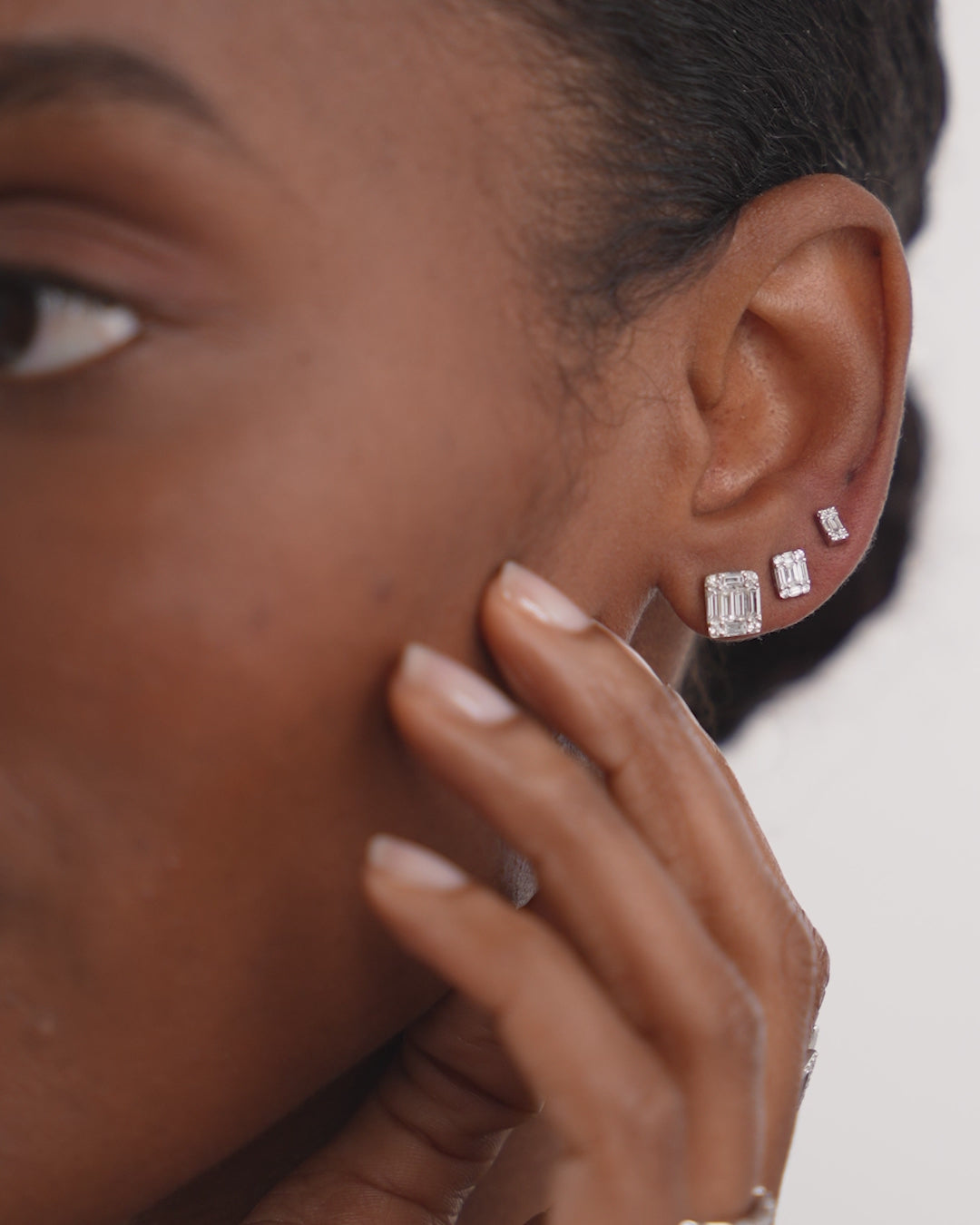 Video of Large Emerald Illusion Studs shown on ear styled with Mini Emerald Illusion Studs and Petite Emerald Illusion Studs in 14K White Gold