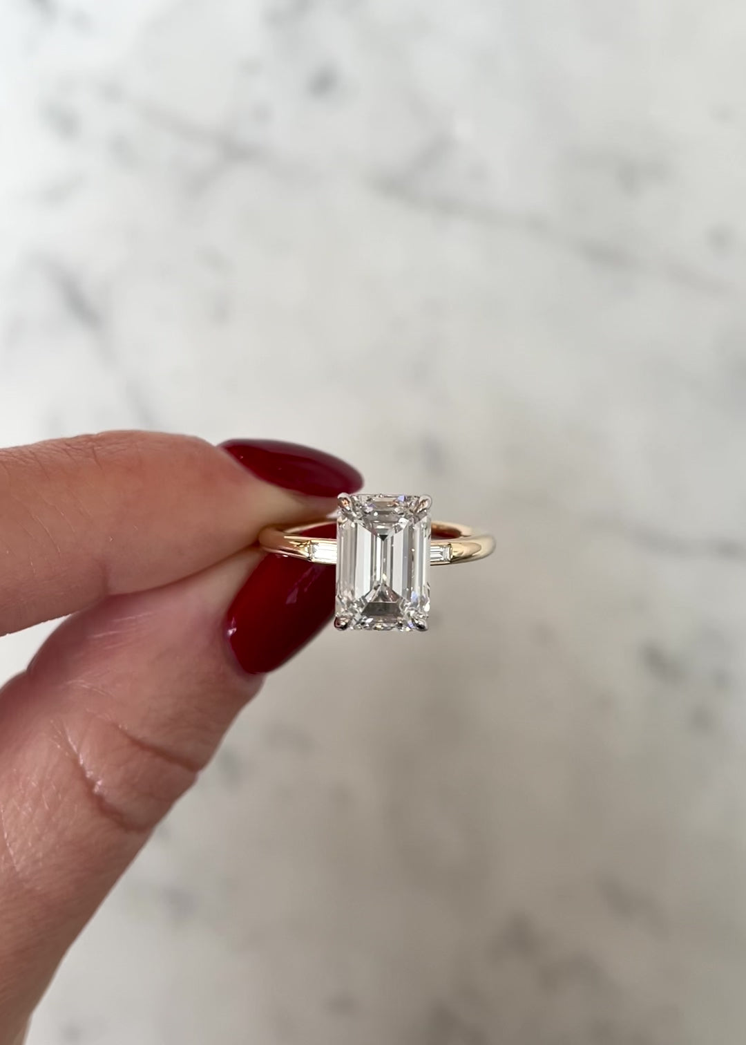 video of LG Emerald in Cloud Three Stone with Baguettes | 14k yellow gold w/ platinum prongs