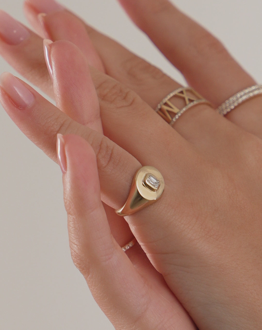Video of the Diamond Signet Pinky Ring worn with Personalized Diamond Roman Numeral Ring and two Stackable Pave Diamond Rings