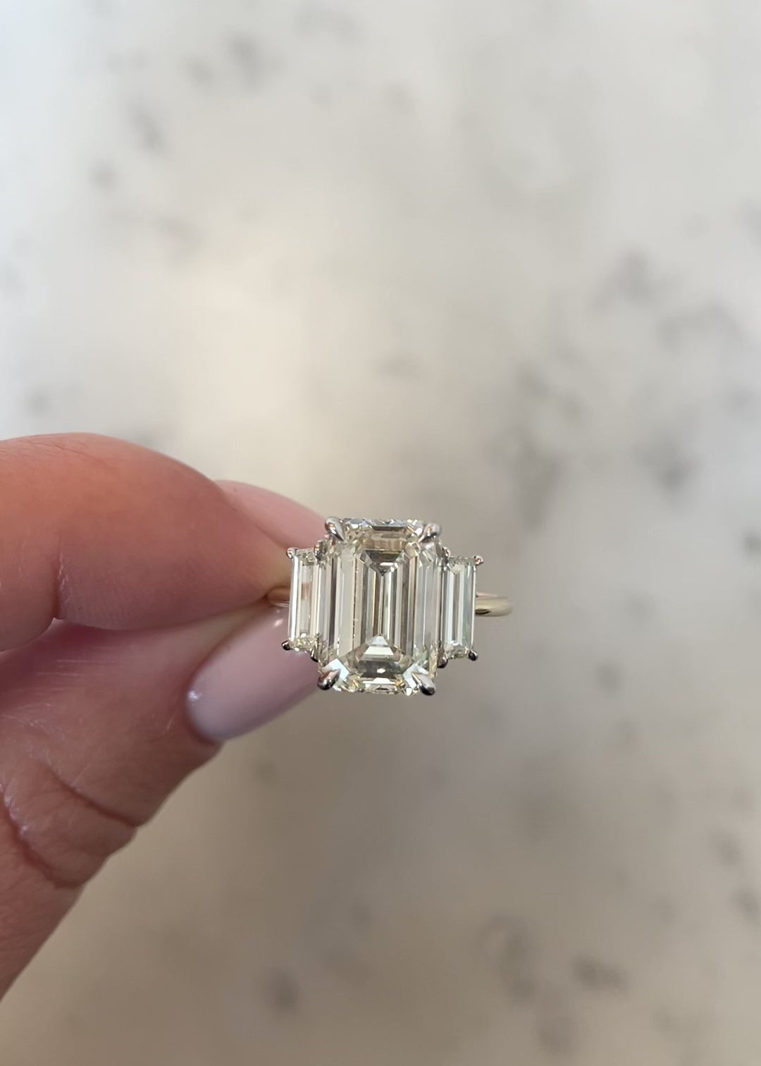 video of 5.02 emerald in the whisper thin three stone with trapezoids
