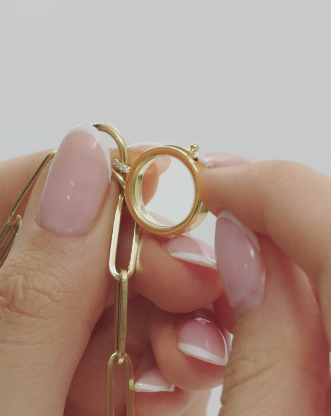 video of someone putting charms inside the charm locket global