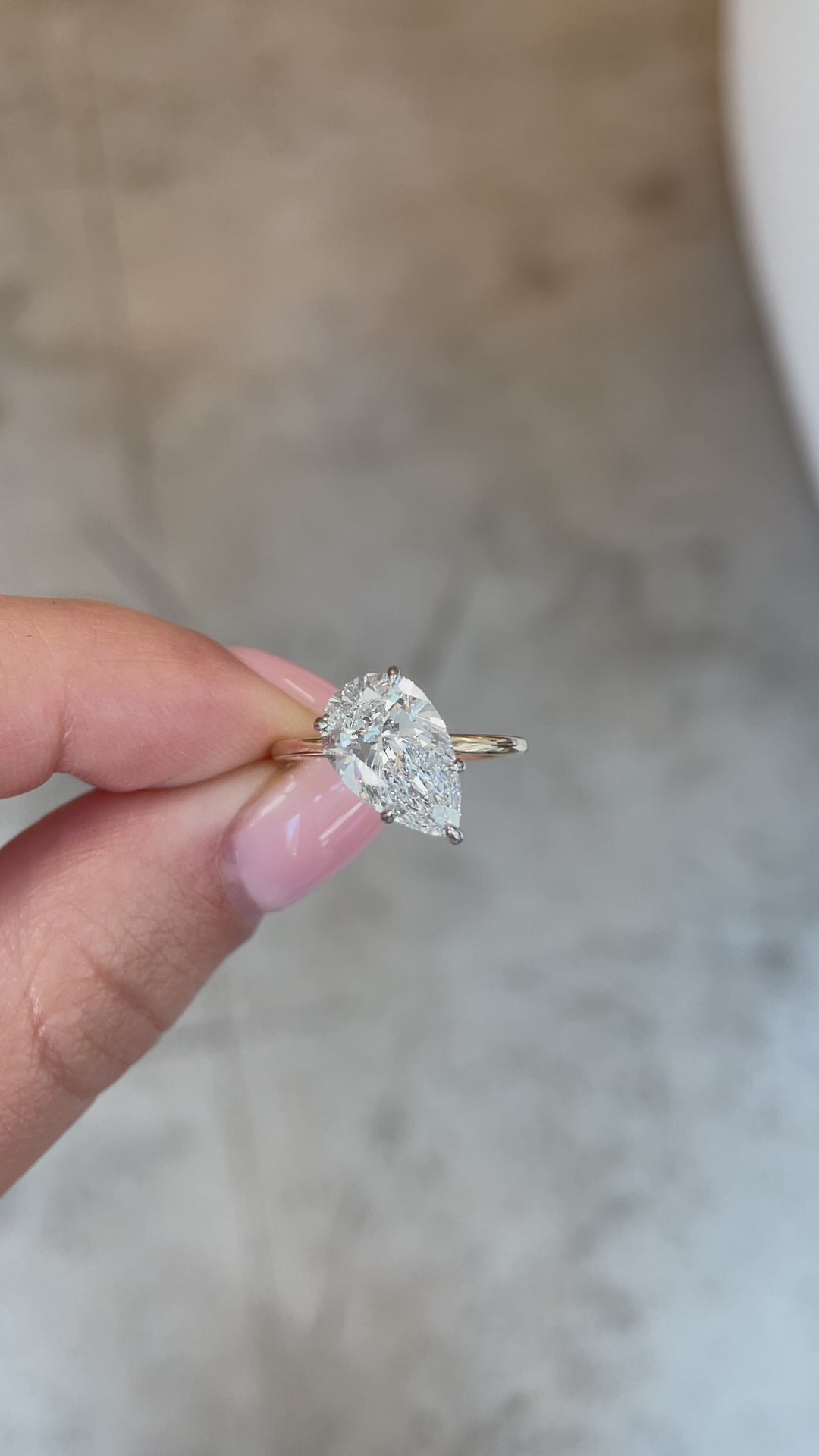 video of slanted pear in the whisper thin with hidden halo | 14k yellow gold w/ platinum prongs