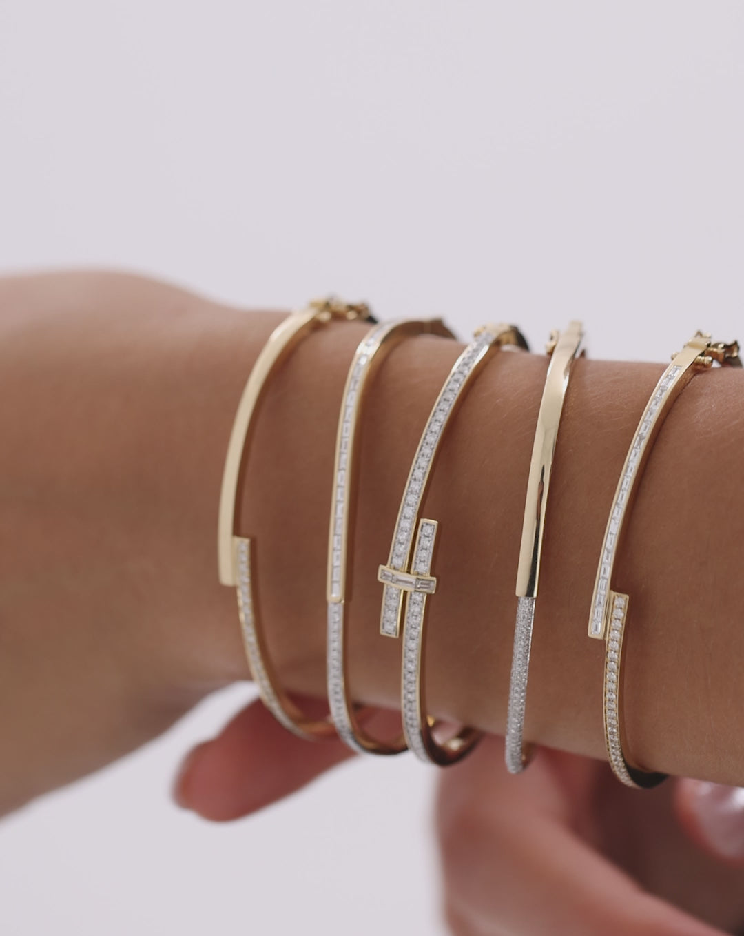 Round Diamond Wrap Bangle rotating to show 360-degree view of sparkling diamonds and gold wrap design in motion