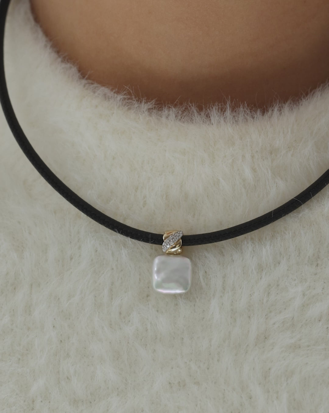 video showcasing pearl pendant on-model