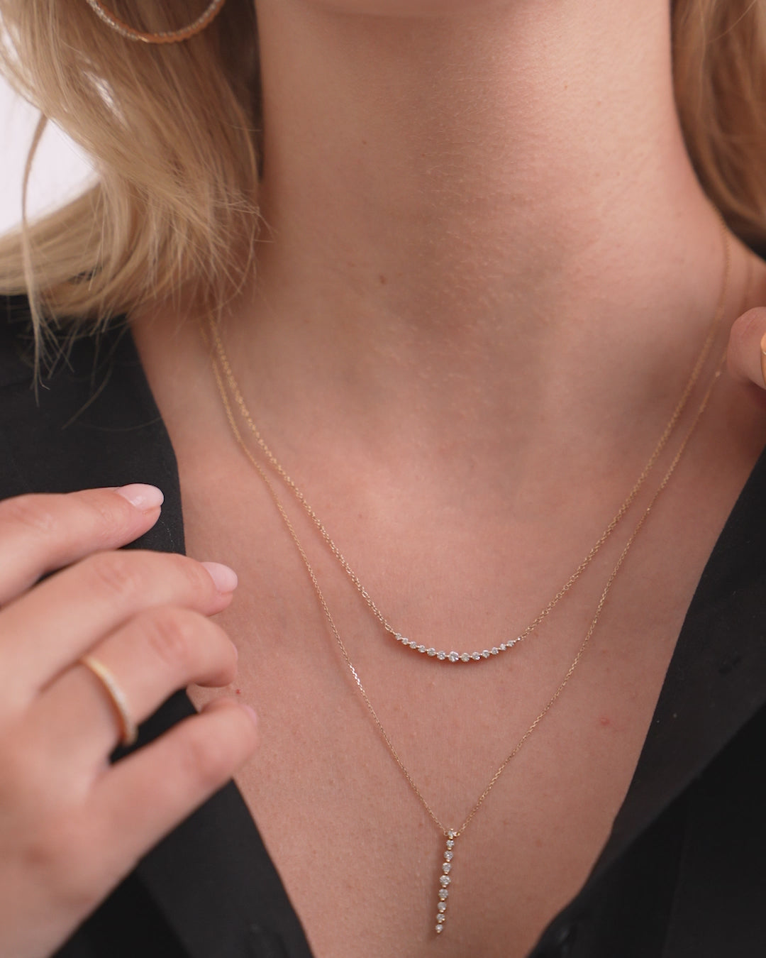 Video of Graduated Single Prong Diamond Necklace layered on neck with another necklace