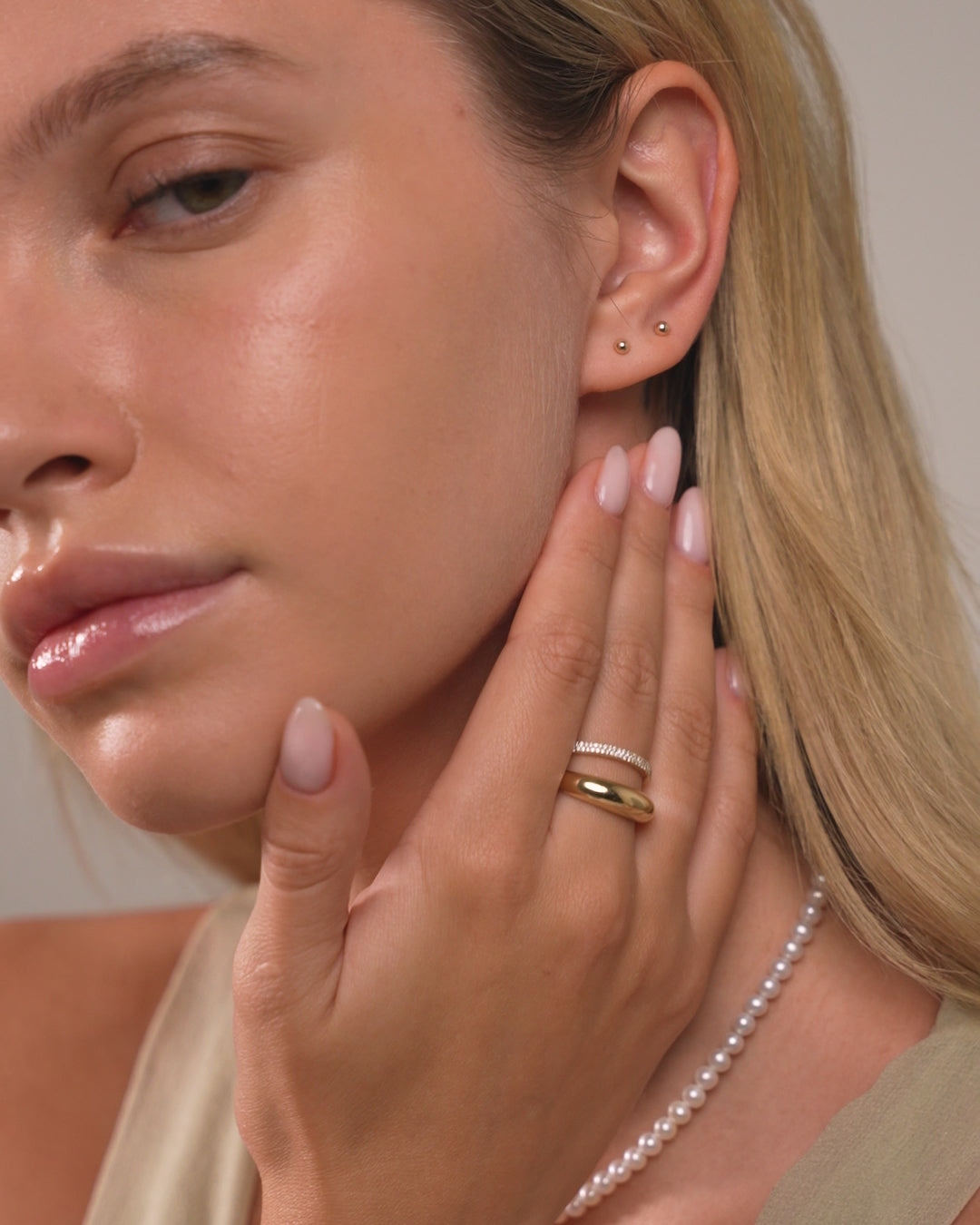 Video of Petite Gold Studs shown styled with different huggies and studs in models ears