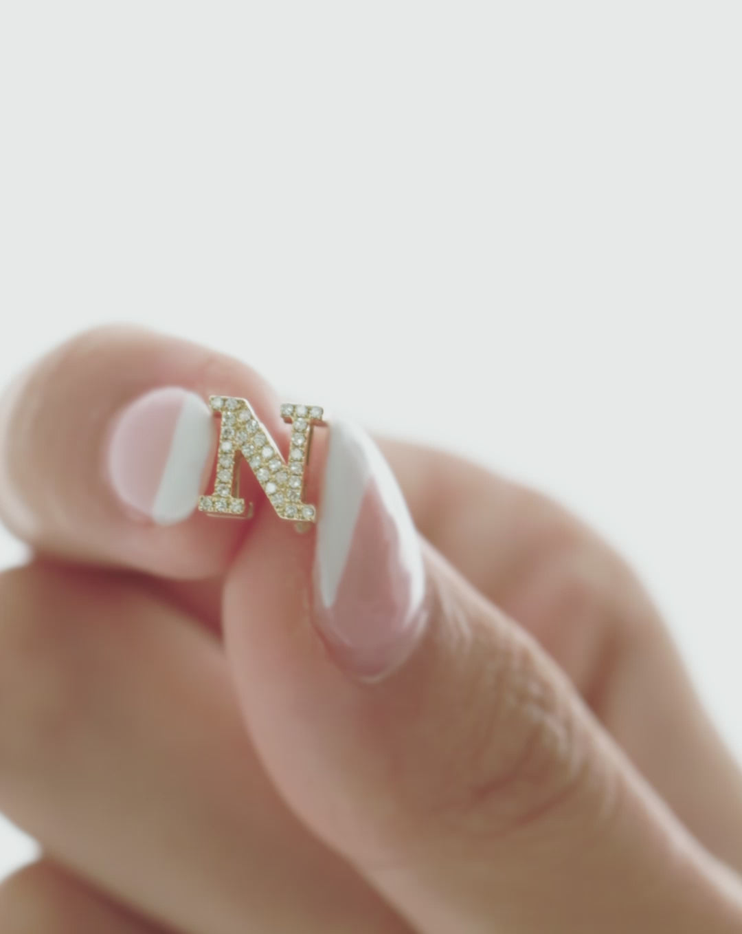 video of someone opening the Initial Bead and adding it to a necklace global