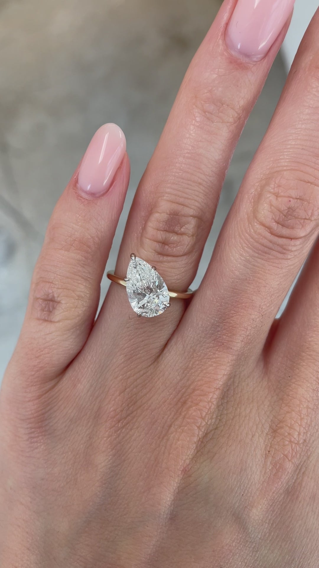 video on model of slanted pear in whisper thin engagement ring