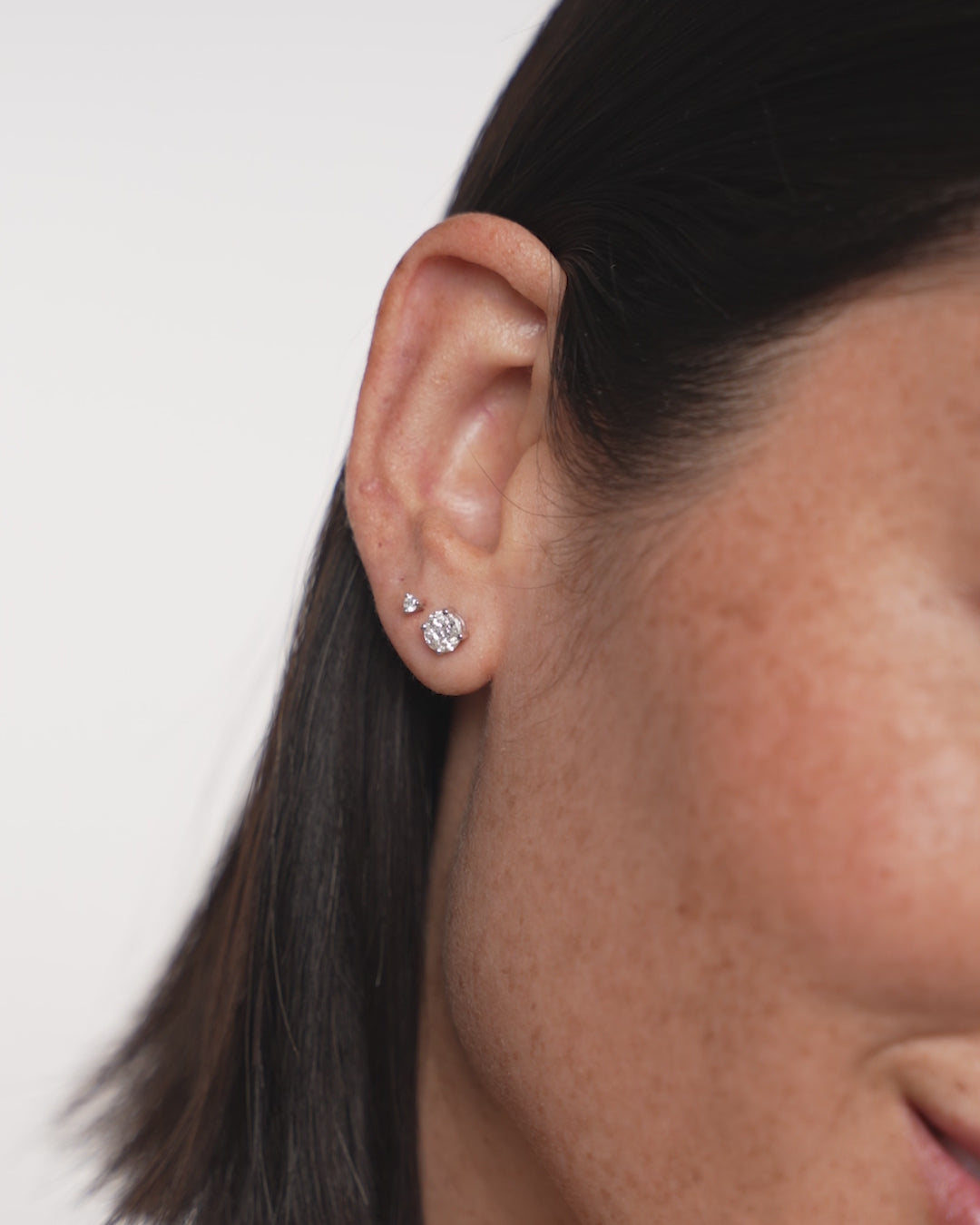 video of round illusion studs on model 14k white gold setting