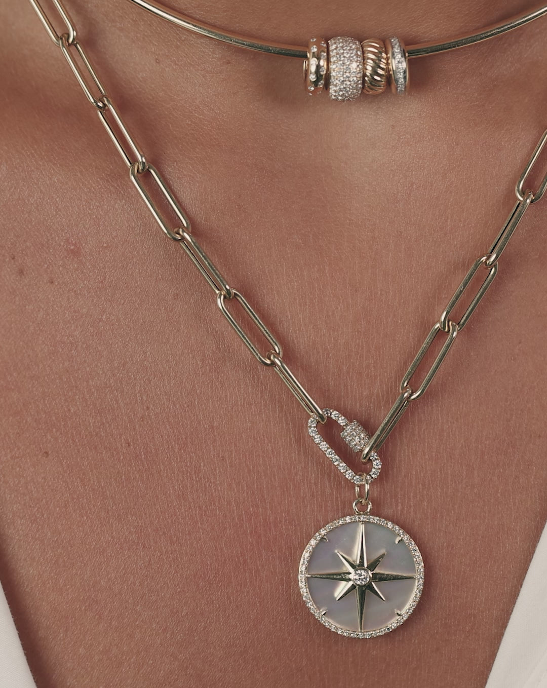 Video showcasing the Fluted Pearl Star Pendant from multiple angles, highlighting the lustrous pearl center and intricate fluted star design in 14k gold