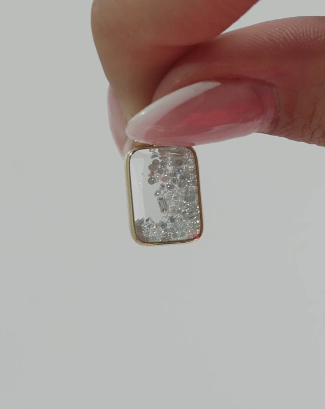Video featuring different shots of our Shaker Emerald Drop Earrings