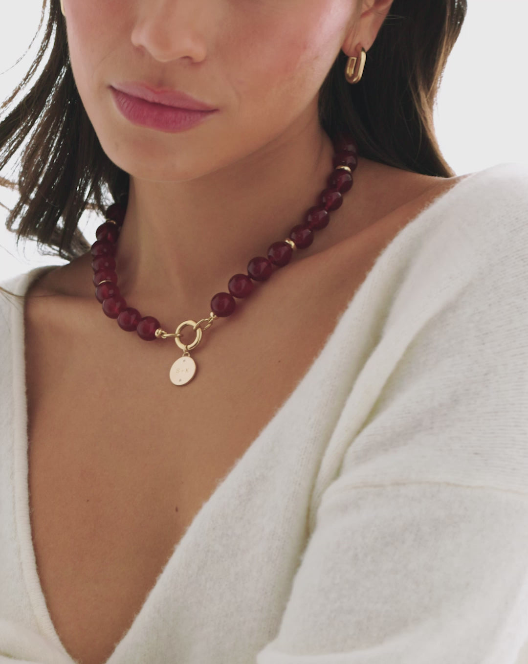 video of model wearing the red agate bead necklace