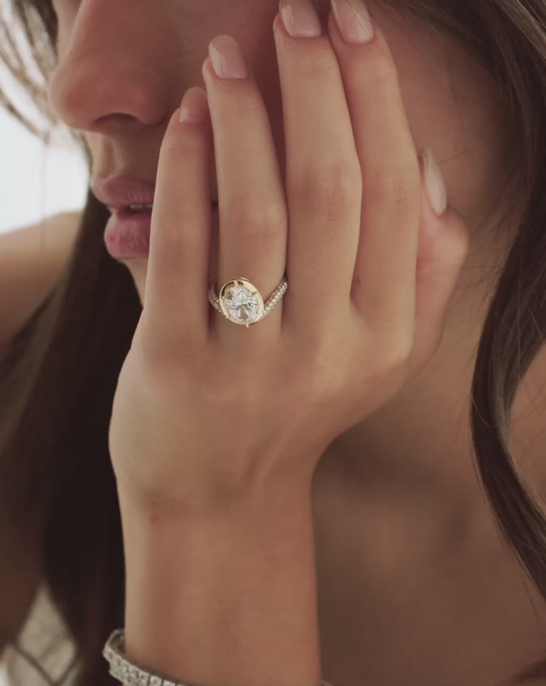 Video of a model wearing the Pavé Nest ring featuring a 3.08-carat oval lab-grown diamond in a 14k yellow gold setting. 14k yellow gold 14k rose gold Platinum 67602394808408 67602061819992 67602395332696