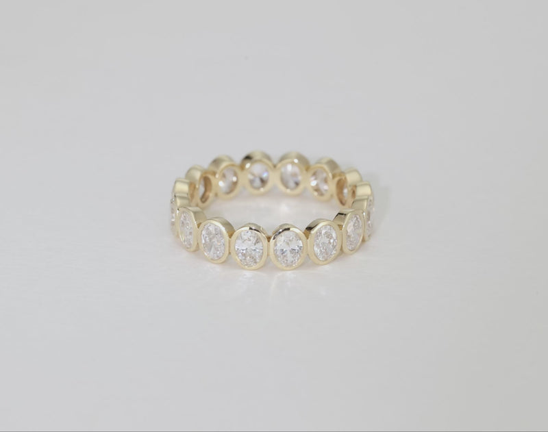 Bridal Wedding Bands 14k Yellow Gold Petite Oval Bezel Eternity Band rotating video