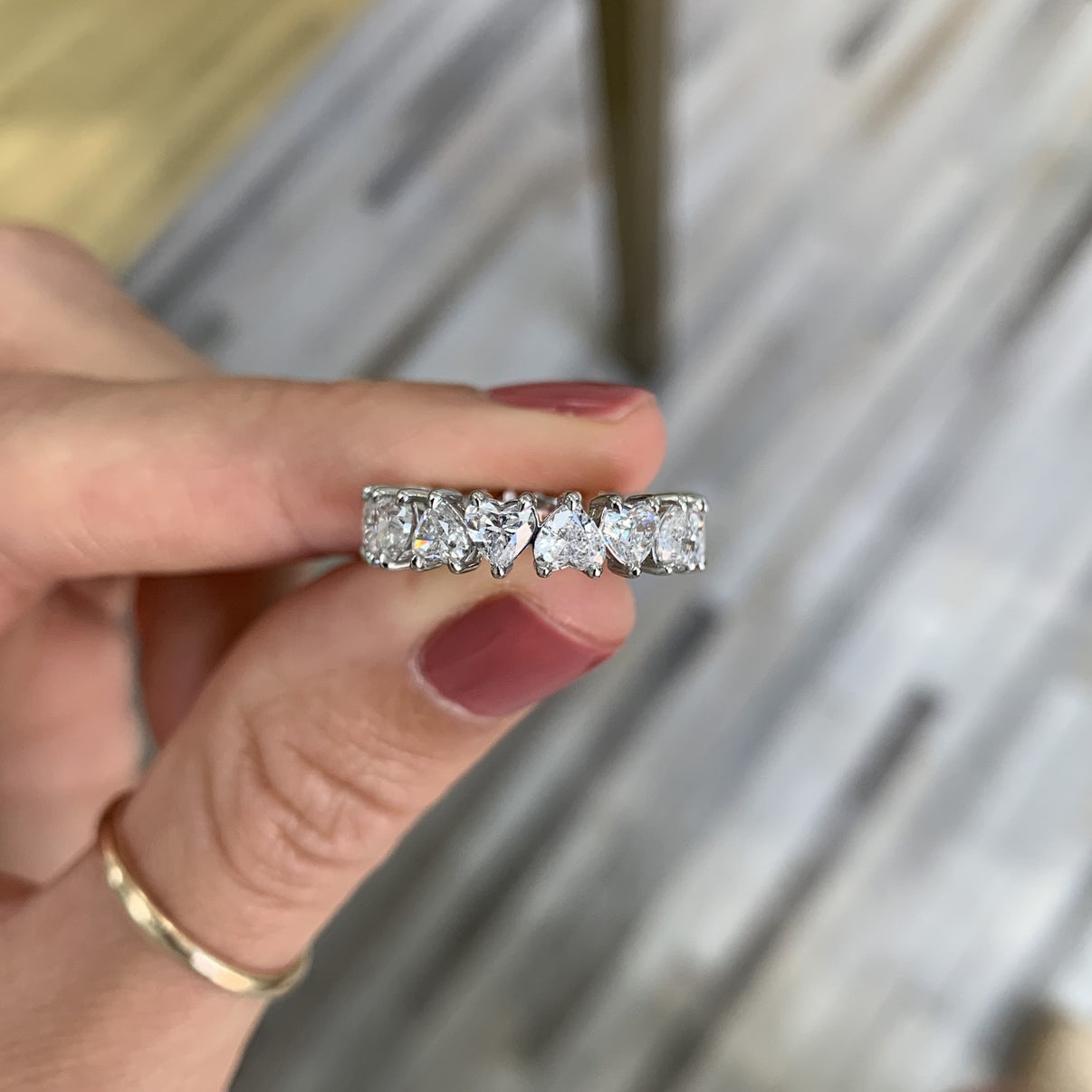 Bridal Wedding Bands Heart Shaped Eternity Band - model holding ring to show detail