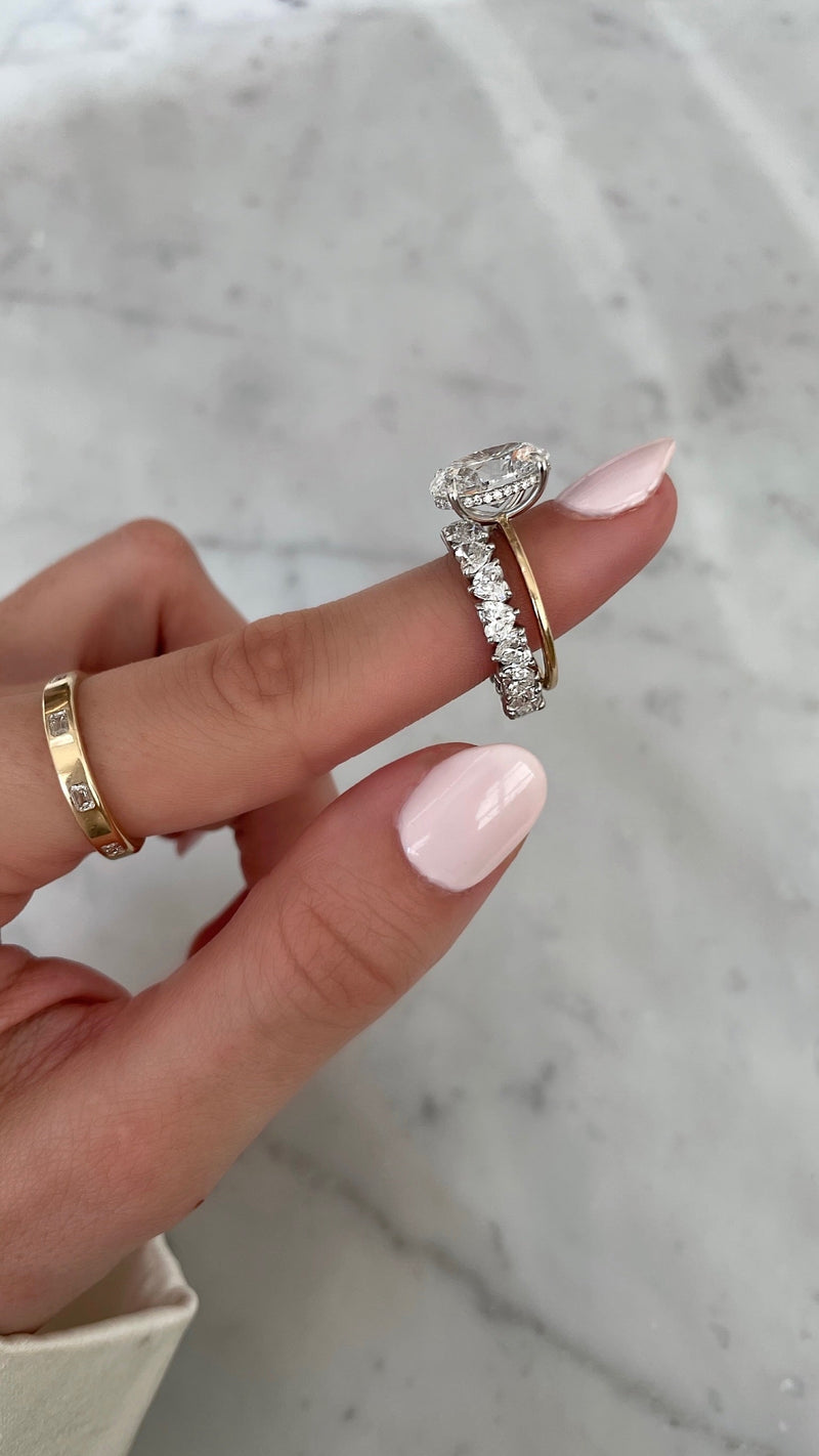 Bridal Wedding Bands Platinum Heart Shaped Eternity Band - styled with oval engagement ring on model shown on pointer finger