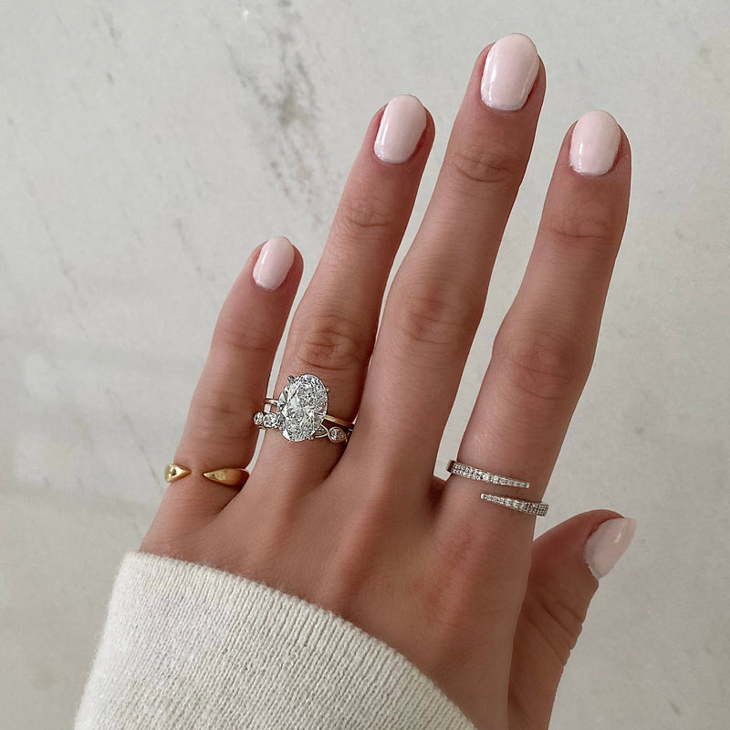 Bridal Wedding Bands Mini Pear Bezel Eternity Band - on model paired with oval engagement ring and 2 fine jewelry rings