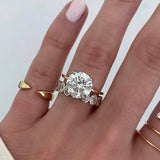 Bridal Wedding Bands Petite Oval Bezel Eternity Band on model stacked with round engagement ring