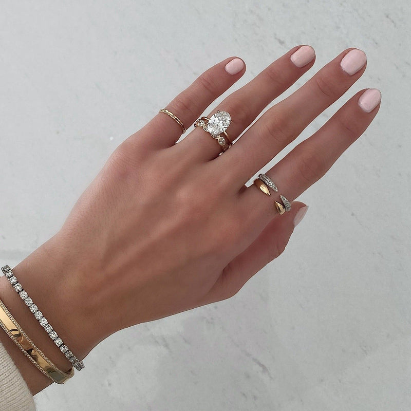 Bridal Wedding Bands Sideways Petite Oval Bezel Eternity Band on model paired with oval engagement ring