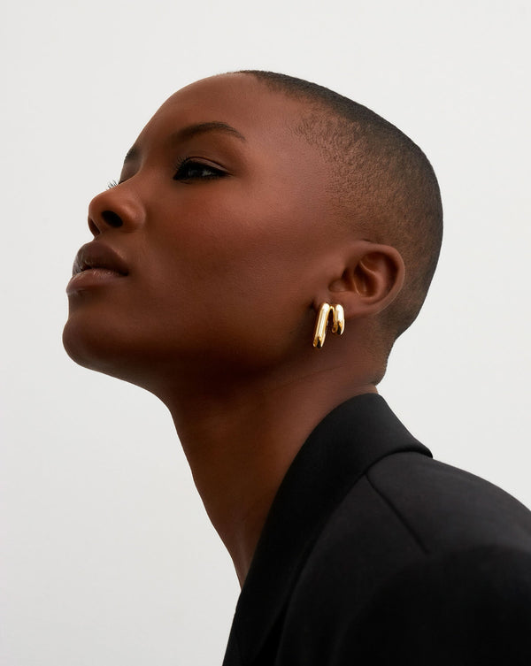 Ring Concierge Earrings Bold Gold Cloud Multi Hoops - On model with model looking off in the distance wearing a black blazer