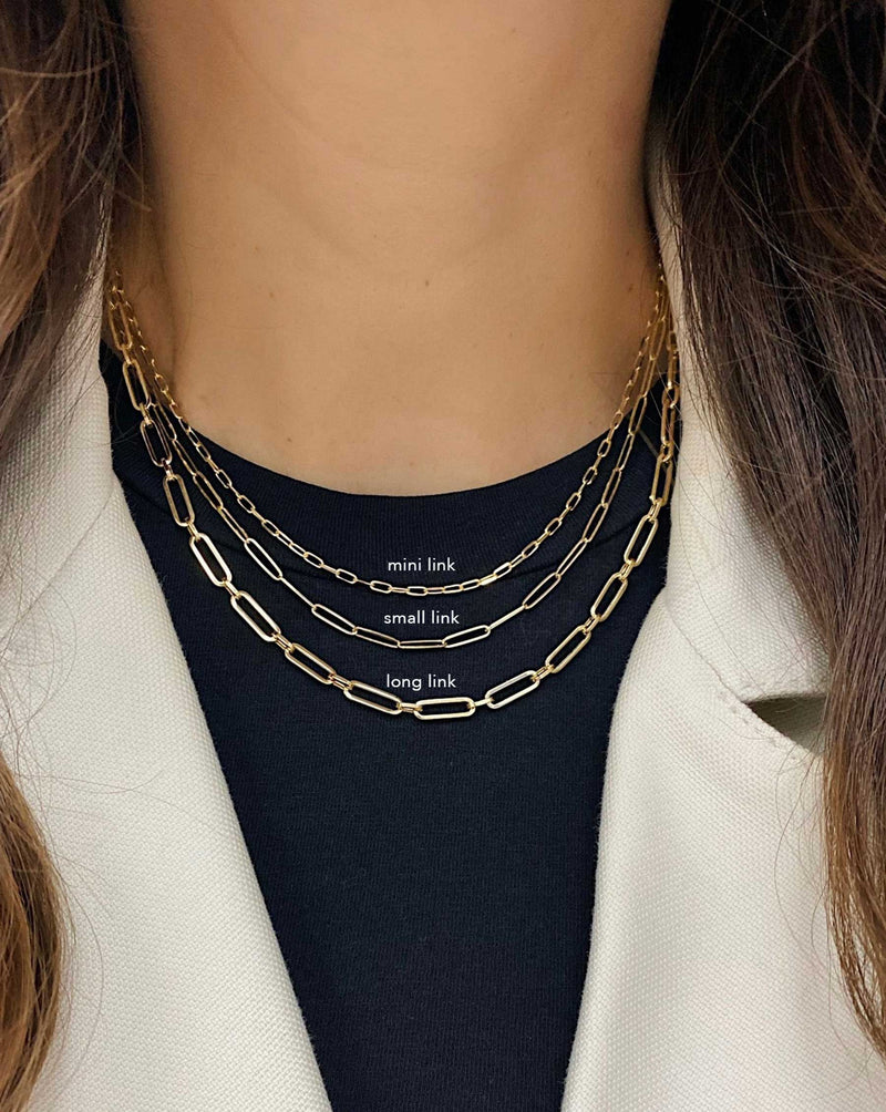 Ring Concierge Necklaces Mini Link Chain Necklace, layered with 2 fine jewelry necklaces, model wearing black top and white blazer