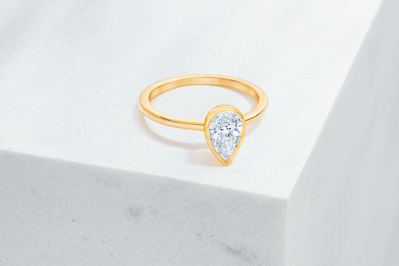 Mercer VOW by Ring Concierge pear bezel engagement ring in yellow gold. 33281414103128