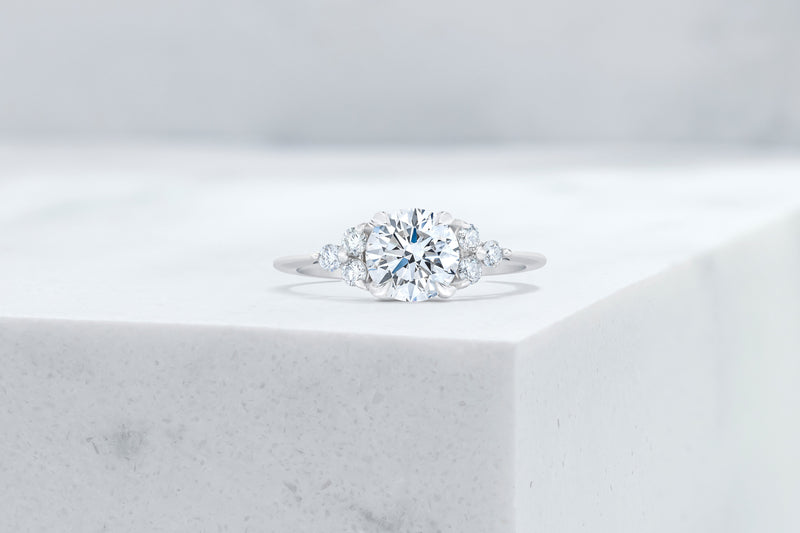 Tribeca VOW by Ring Concierge round with trio side stones engagement ring in platinum. 33281407680600
