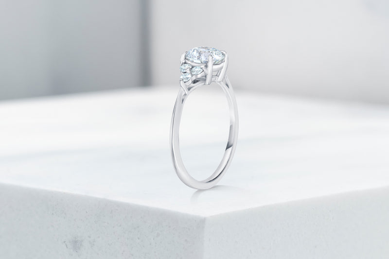 Tribeca VOW by Ring Concierge round with trio side stones engagement ring in platinum. 33281407680600