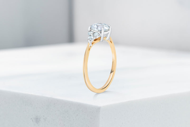 Tribeca VOW by Ring Concierge round with trio side stones engagement ring in yellow gold. 33281407615064