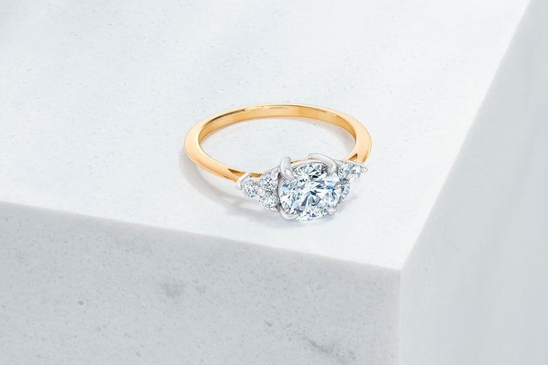 Tribeca VOW by Ring Concierge round with trio side stones engagement ring in yellow gold. 33281407615064